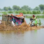 Flood victims protect homes against devastation; aid arrives